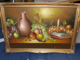 A large framed Oil on board of a still life, fruit, candle, books,