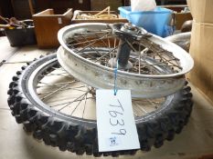 Two motorcycle wheels, one with 90/90 x 21" aggressive tread pattern tyre.