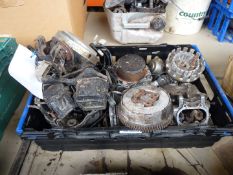 A box of mixed makes spares including a headlamp, hoses, instruments, a cylinder and piston,