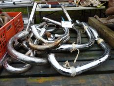 A quantity of chromium plated motorcycle exhaust pipes.