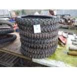 Seven 21'' diameter aggressive tread pattern motorcycle tyres.