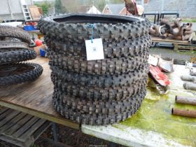 Seven 21'' diameter aggressive tread pattern motorcycle tyres.