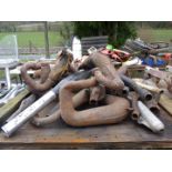 A quantity of exhaust pipes/silencers.