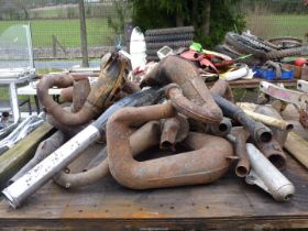 A quantity of exhaust pipes/silencers.