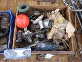 A drawer of carburettors, foot-peg, a horn and a pair of pistons for Triumph 500cc T100 (2.