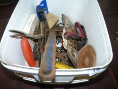 A tub of mixed tools including wire strippers, Stilsons, a surform, a multi-tool, a Vise-Grip,