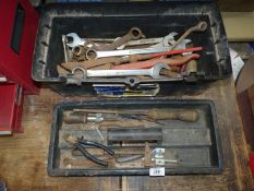 A plastic toolbox containing various combination spanners, long-reach sockets,