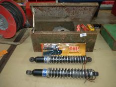 A steel Tool box containing a pair of Hagen shock absorber/suspension units,