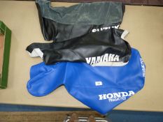 Three Suzuki seat covers:two black, one blue.