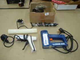 A box of electrical items including a 230 volt electric staple/nail gun, a glue gun with cartridges,