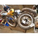 A Suzuki RM500 (1984) frame, two sets of forks, three rear arms, five wheels and tyres, a fuel tank,