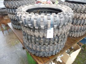 Five of 18'' diameter aggressive tread pattern motorcycle tyres.