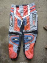 A pair of fabric competition protective trousers, 36'' waist approximately.