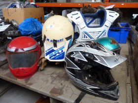 Four crash helmets, a seat, a plastic jacket, etc.