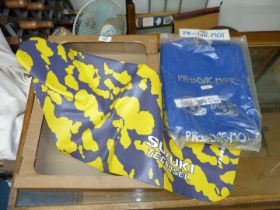 Two Suzuki seat covers : blue and yellow.