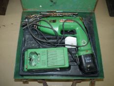 A metal cased Hitachi 12 volt EB12 re-chargeable electric Drill and charger and odd drill bits and