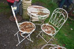 A metal bistro Table, 24'' diameter x 29 1/2'' high and a pair of chairs.