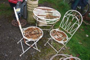A metal bistro Table, 24'' diameter x 29 1/2'' high and a pair of chairs.