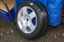 An alloy wheel and tyre (new for Audi 2004), five stud fixing, 205/55 R16.