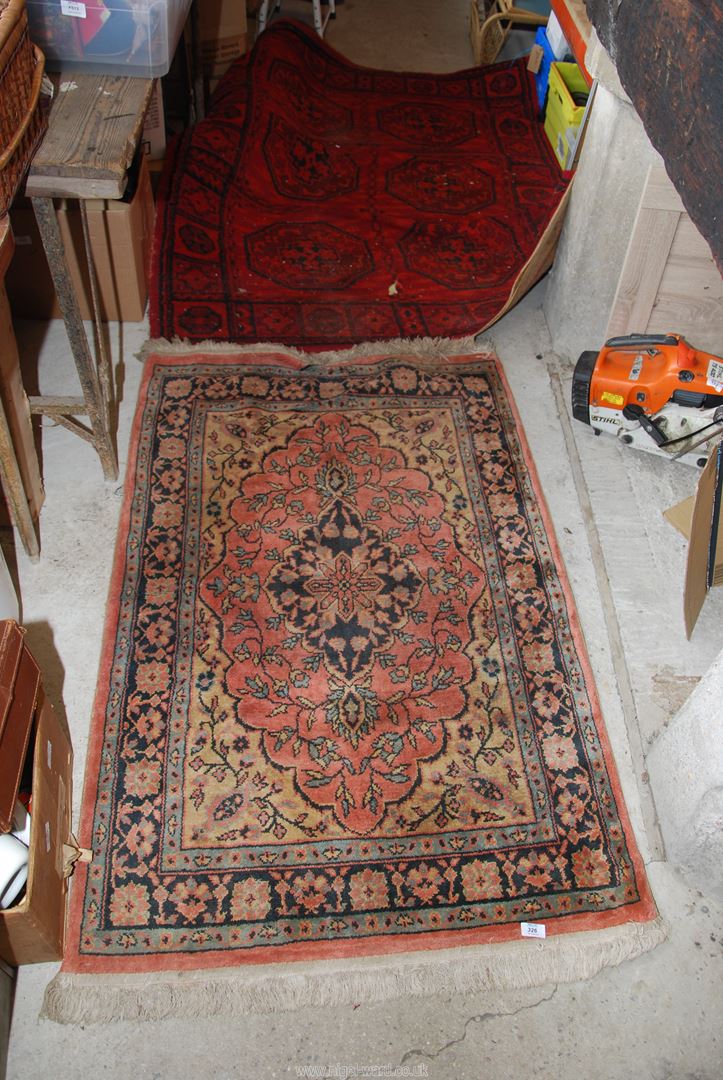 Two rugs : red and multi-coloured.