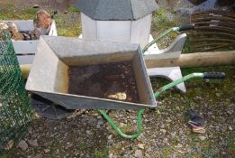 A galvanised Wheelbarrow with solid wheel.