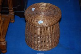 A lidded wicker basket 13" high.