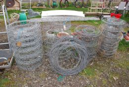 Four rolls of sheep netting and a roll of plain wire.