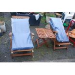 A Teak set of two loungers and table.