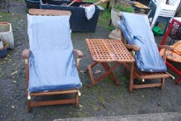 A Teak set of two loungers and table.