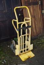 A yellow step-walker Sack Truck.