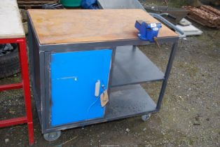 A Workbench with lockable cupboard and 4'' vice, 37'' x 22 1/2'' x 32'' high, on castors.