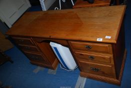 A Pine double pedestal kneehole desk, each pedestal with three drawers, plus frieze drawer,