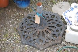 A large Cast Iron parasol stand.