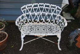 A cast iron two seater garden Bench, 37'' wide x 32'' high.