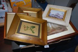 A box of frames and prints.