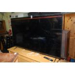 A Logik 64'' flat screen TV with remote.