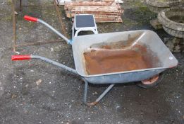 A galvanised wheelbarrow with pneumatic tyre (flat).