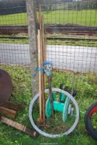 Gardening tools incl. forks, shears, plain galvanised wire and a hose reel.