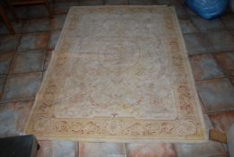 A Laura Ashley rug in cream, gold and rust, 53" x 78".