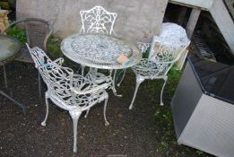 An aluminium patio table, 32'' diameter x 27'' high and an associated set of three chairs.