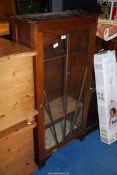 An oak glass fronted display cabinet 22 1/2" wide x 11" deep x 47" high.