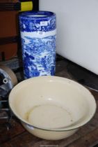 An enamel wash bowl and blue and white china umbrella stand.