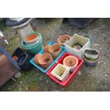 A good quantity of plastic and terracotta pots.