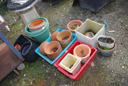 A good quantity of plastic and terracotta pots.