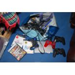 A Playstation 2 with remotes and games.