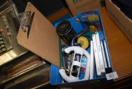A quantity of miscellanea to include; Wii games, tyre pressure gauge, tine, etc.