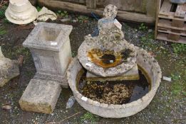 A water feature and a hollow concrete stand marked AD 2000.