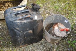 A galvanised bucket, a grain scoop and a modern jerry can.