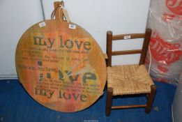 A 'John Hencher' dough board and a seagrass seated dolls/childs chair.