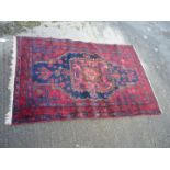 A red ground, border pattern fringed rug, 41'' x 64''.